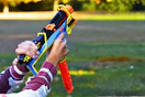 Lifestyle image of the Nerf Mirage Blaster (close up shot of someone holding it ourdoors)