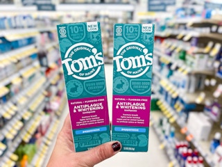 hand holding two of tom of maines toothpaste