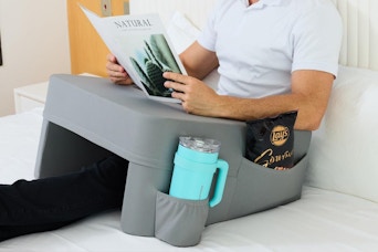 man using lap reading pillow