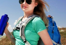 a woman outside with a backpack and waist fan on 