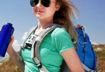 a woman outside with a backpack and waist fan on 