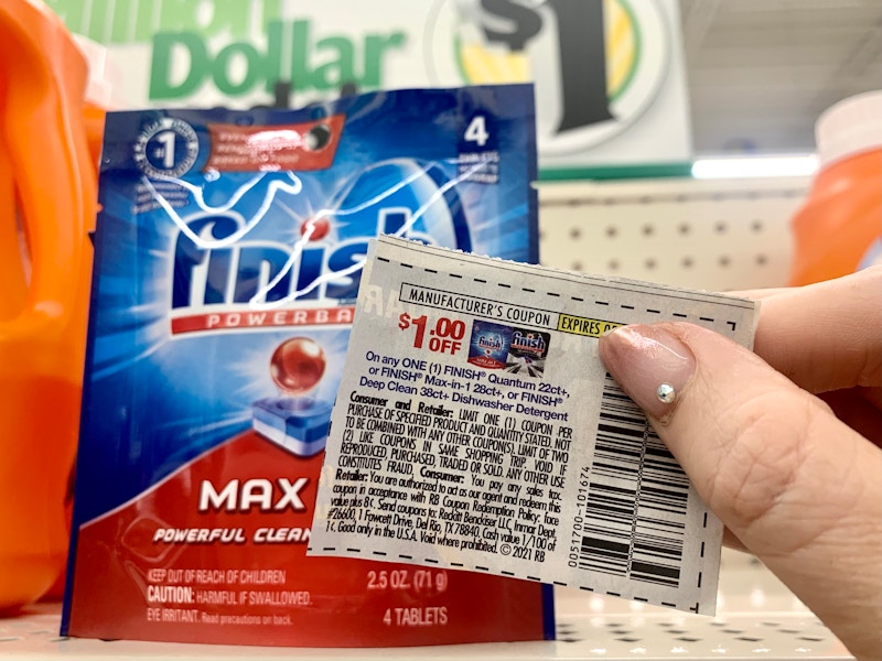 coupon being held in front of finish max dishwashing pods