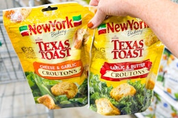 hand holding two bags of new york bakery croutons