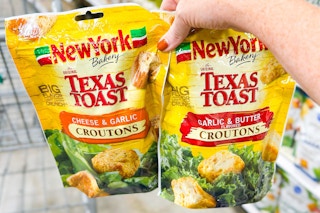 hand holding two bags of new york bakery croutons