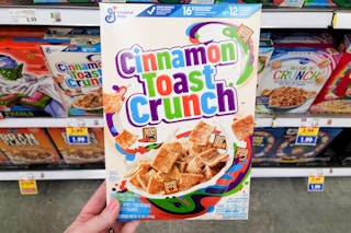 hand holding a box of general mills cereal at kroger