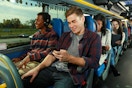 People on their phones and laptops while riding on a Megabus
