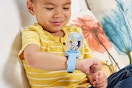 a boy playing with a bluey watch