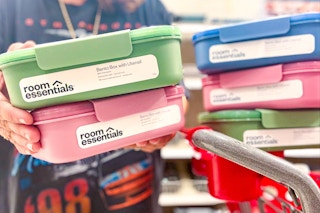 hand holding room essentials bento boxes in front of target cart