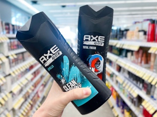 hand holding two bottles of axe body wash