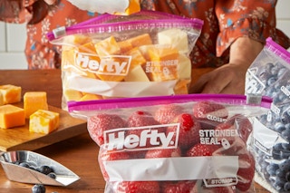 Person putting away food in Hefty Slider Storage Bags