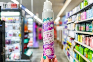 hand holding batiste dry shampoo in a store aisle