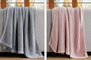 2 lifestyle images of Ugg throw blankets in 2 colors