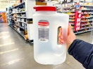 hand holding rubbermaid pitcher in walmart aisle