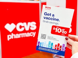 hand holding a vaccine coupon in front of a cvs