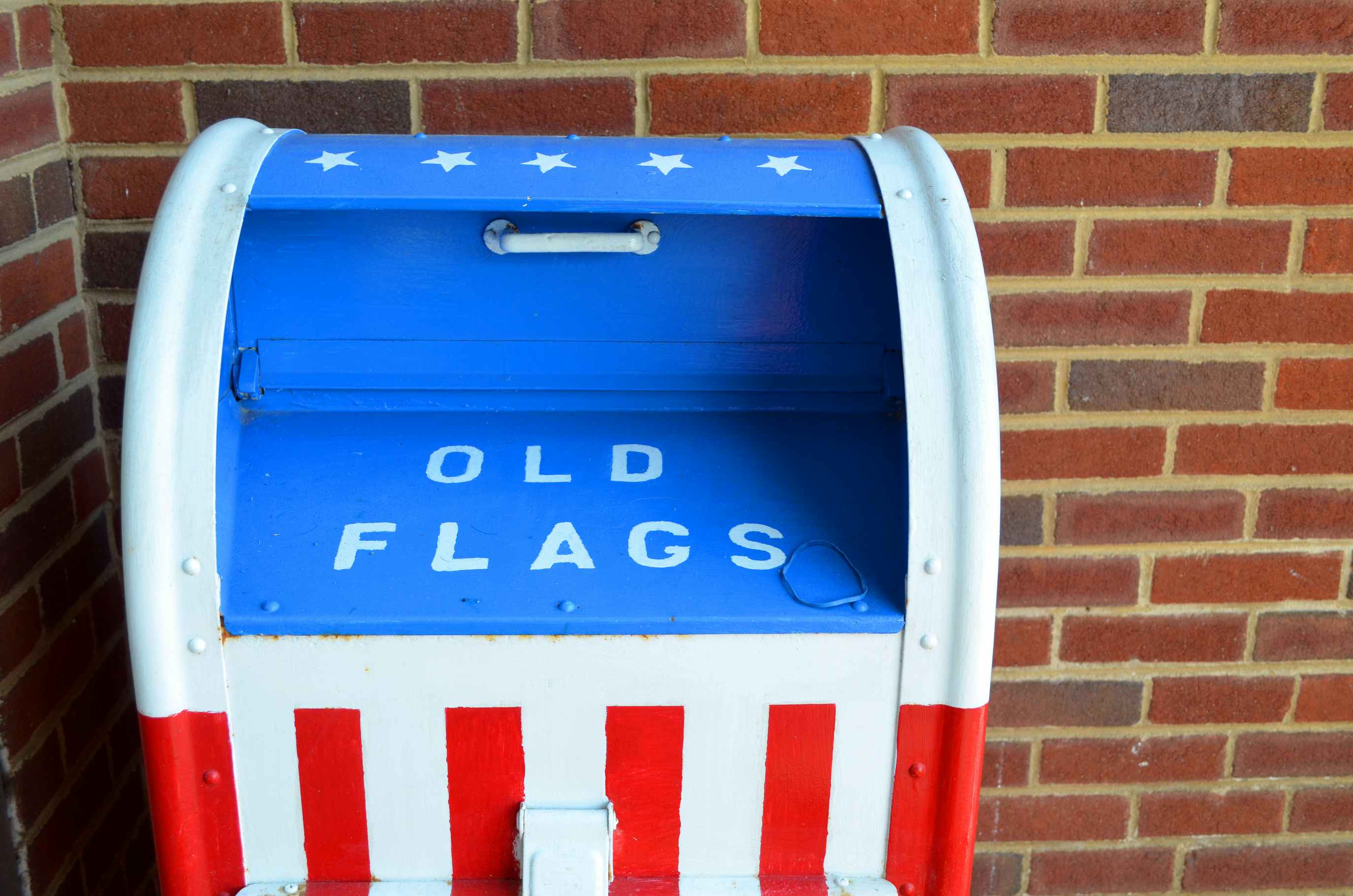 A red, white and blue deposit box marked for old American flag disposal