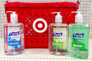 3 purell hand sanitizers sitting on a shelf in front of a target basket