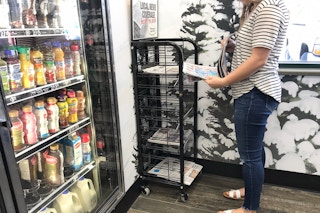 someone grabbing paper at gas station