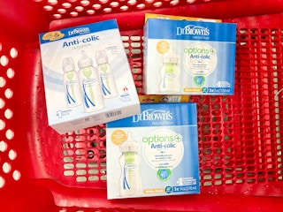 A variety of Dr. Brown bottles lying in a store cart.