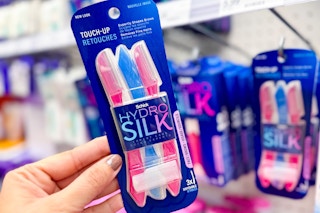 hand holding a pack of schick hydro-silk touch-up razors in front of razors