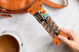 a woman holding a kind thins bar