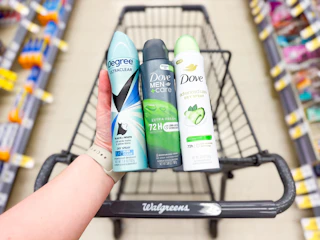 hand holding degree and dove deodorant dry sprays