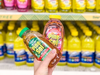 hand holding bottles of pine sol