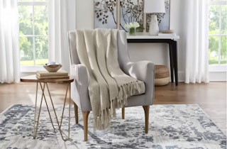 Beige Throw Blanket draped over accent chair in living room