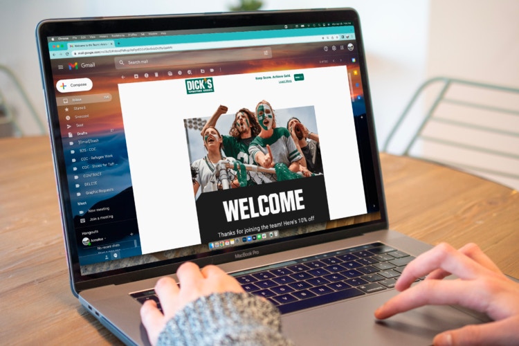 A person looking at a Dicks' Sporting Goods welcome email on a Macbook computer.