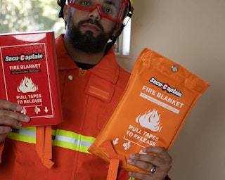 a man holding a fire blanket 