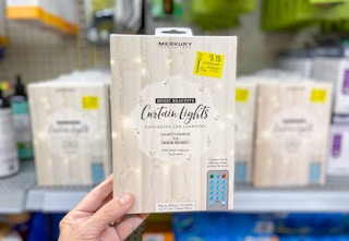 hand holding merkury inovations curtain lights at walmart