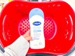 hand holding a cetaphil body wash over a target basket