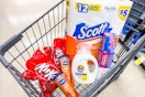 kit kat candy, vaseline lotion, tide simply detergent, scott toilet paper, and food storage bags in a cart