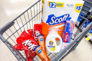kit kat candy, vaseline lotion, tide simply detergent, scott toilet paper, and food storage bags in a cart