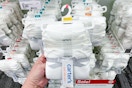 hand holding a pack of carter's bodysuits at target