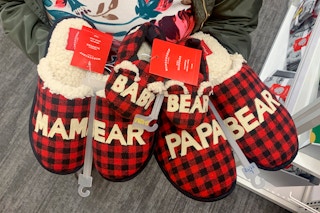 woman holding christmas slippers at target