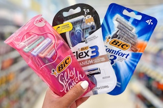 hand holding three packs of Bic razors