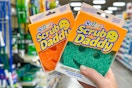 hand holding scrub daddy sponges