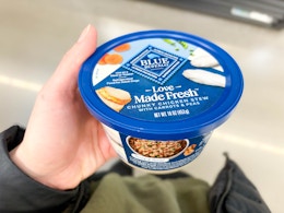 hand holding a container of Blue Buffalo Love Made Fresh dog food