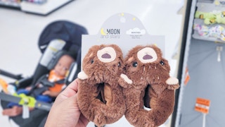 hand holding a pair of baby slippers