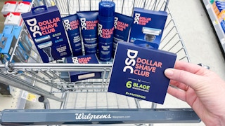 Dollar Shave Club blades box being held infront of a Walgreens cart