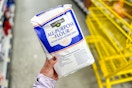 hand holding a bag of clover valley flour