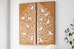 Lifestyle image of Home Decorators wooden wall art panels featuring tree branches and birds (hanging on wall)