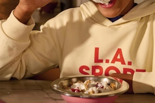 a boy eating food from a hydro flask bowl