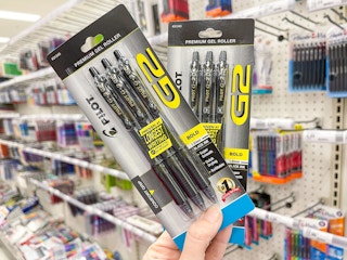 a person holding up pilot pens