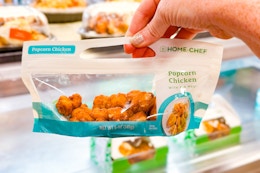 hand holding a bag of home chef popcorn chicken