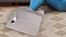 a person with their feet in a grey foot warmer pad