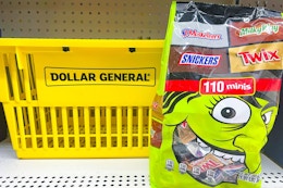 mars halloween candy bag sitting next to dollar general shopping basket