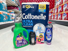 cottonelle, gain, dawn, downy, and febreze sitting in front a target cart