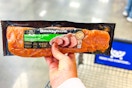 hand holding smithfield pork tenderloin over shopping cart