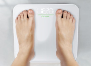 a person standing on a digital scale 